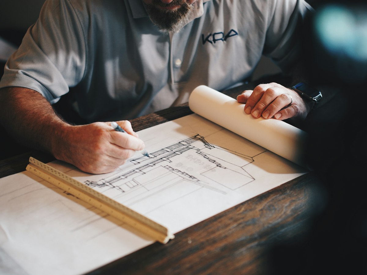 Reviewing building plans to prepare a roof repair and maintenance plan