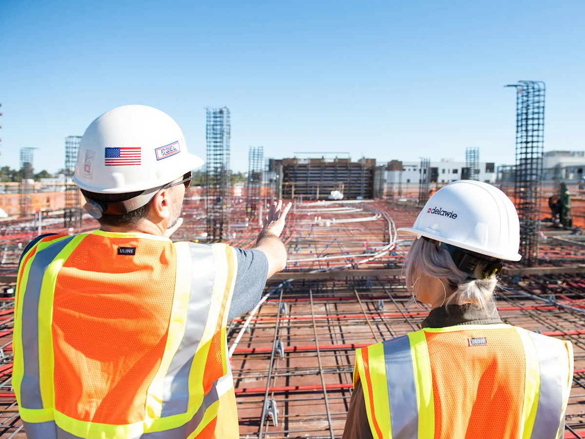 Commercial crew members in safety gear reviewing a job site